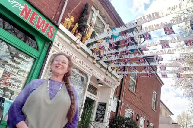 Susan Hurst outside Flowers by Lord Hurst, in Doncaster, decorated for the Tour de Yorkshire