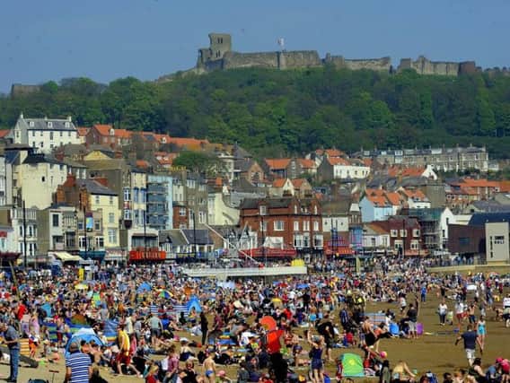 People enjoy the hot summer sun on the beach at South Bay in Scarborough on Monday. Picture by Simon Hulme
