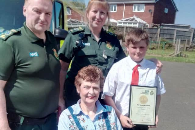 Ambulance crew members Phil Tunnicliffe and Claire Penney, with Toby Rose, right, and Jane Roe, front, at Harworth Alll Saints Church of England Primary School.