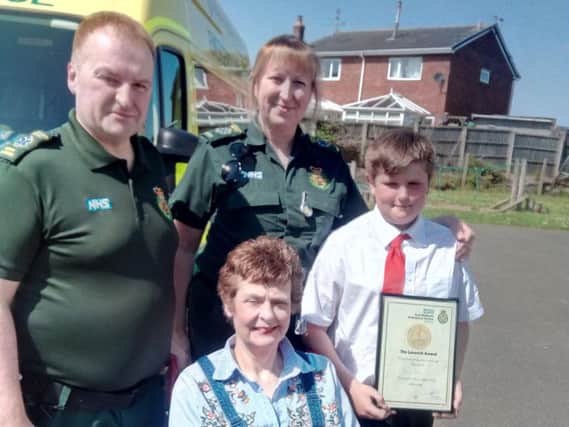 Ambulance crew members Phil Tunnicliffe and Claire Penney, with Toby Rose, right, and Jane Roe, front, at Harworth Alll Saints Church of England Primary School.