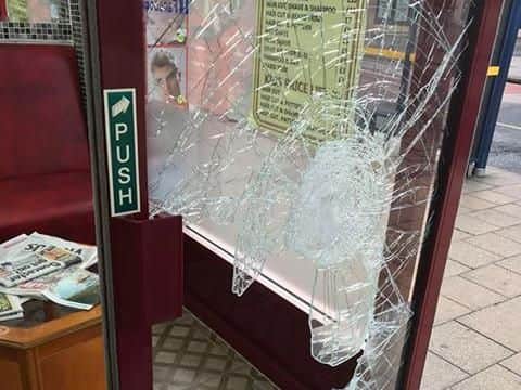 The smashed door at the Best Barbers.
