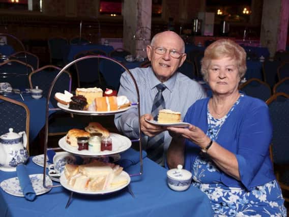 Pictured eating the cake at afternoon tea are Bill and Francis Shane.