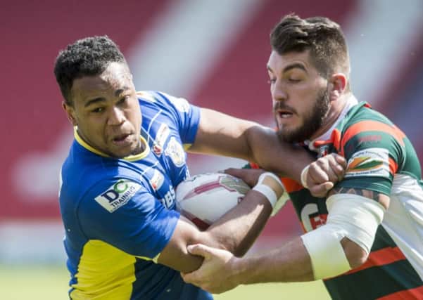 Charlie Martin looks to break through a tackle from former Dons ace Duane Straughier