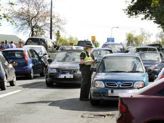 Police giving out parking tickets in a previous operation in South Yorkshire. Pic: Steve Ellis
